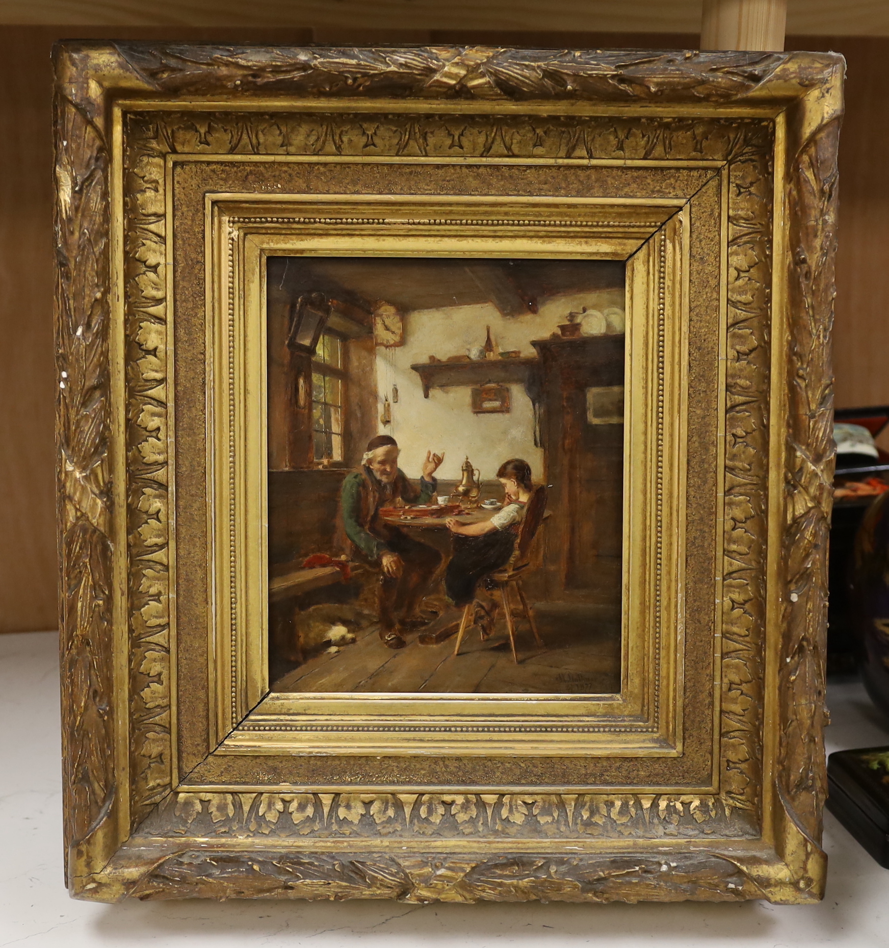 19th century Continental School, oil on board, Figures in a cottage interior, indistinctly signed and dated 1877, 21 x 17cm, housed in ornate gilt frame